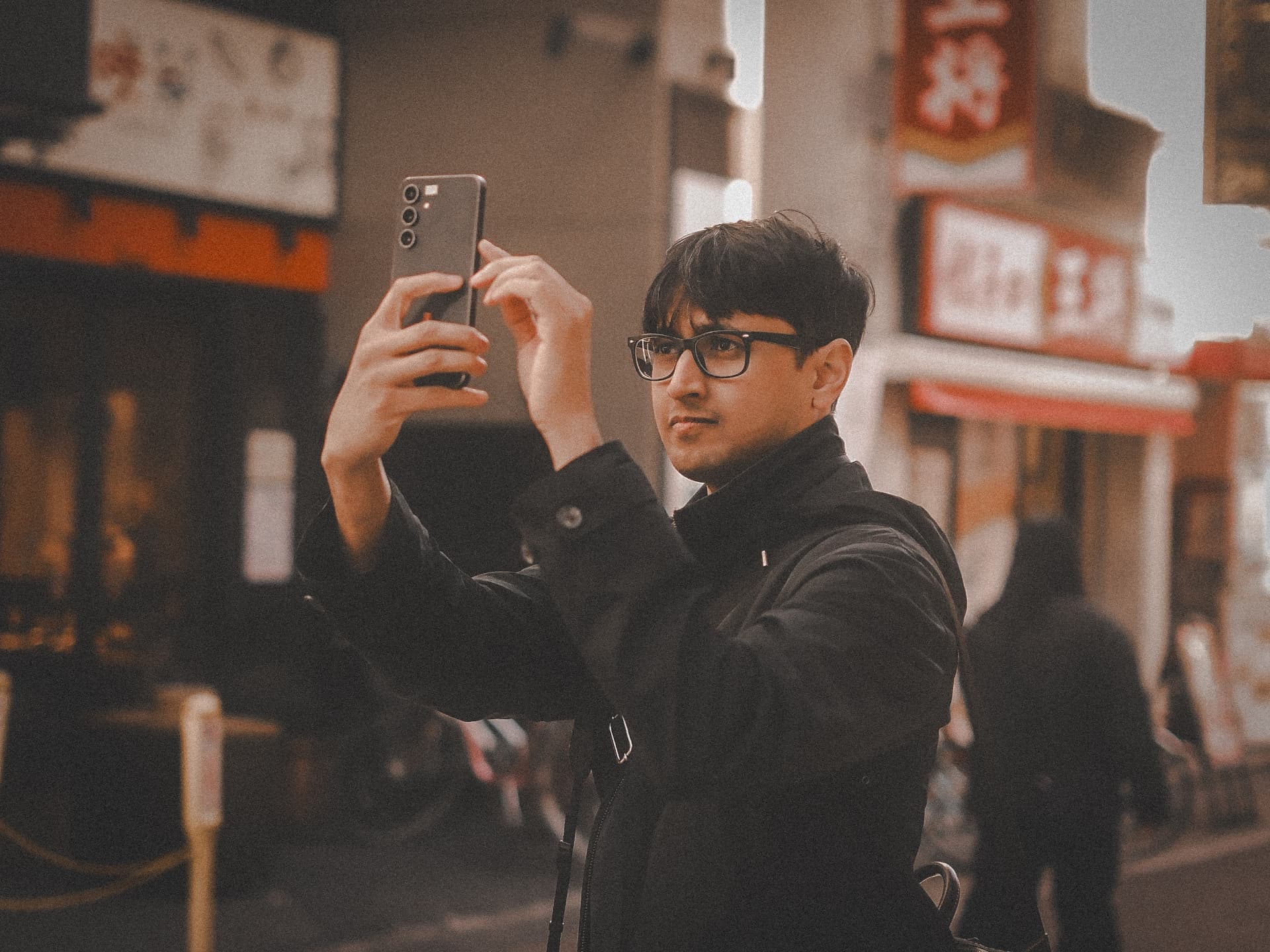 Zeal taking a photo on a quiet evening street in Japan