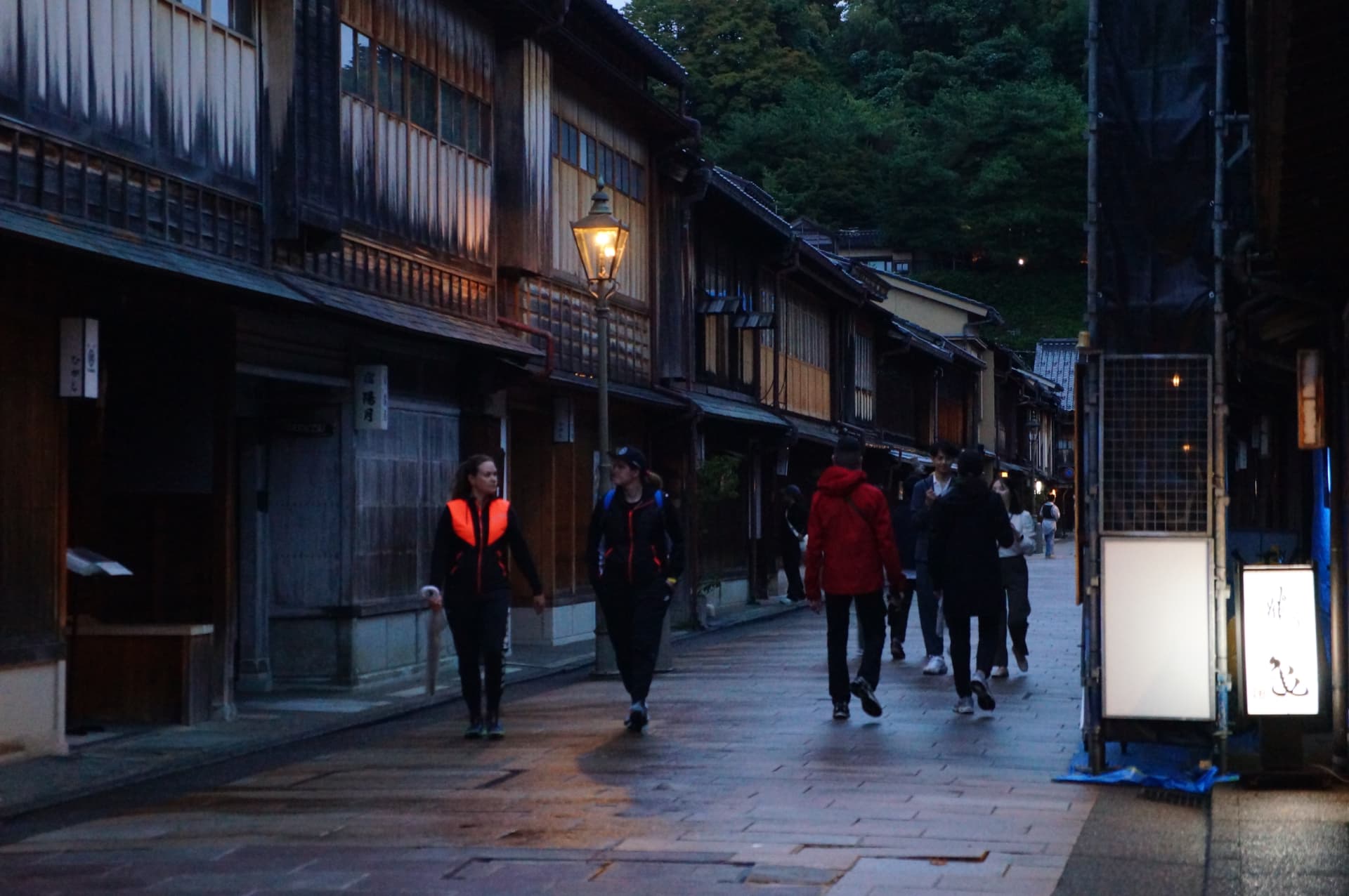 Lantern-lit wooden teahouse street in Kanazawa at dusk