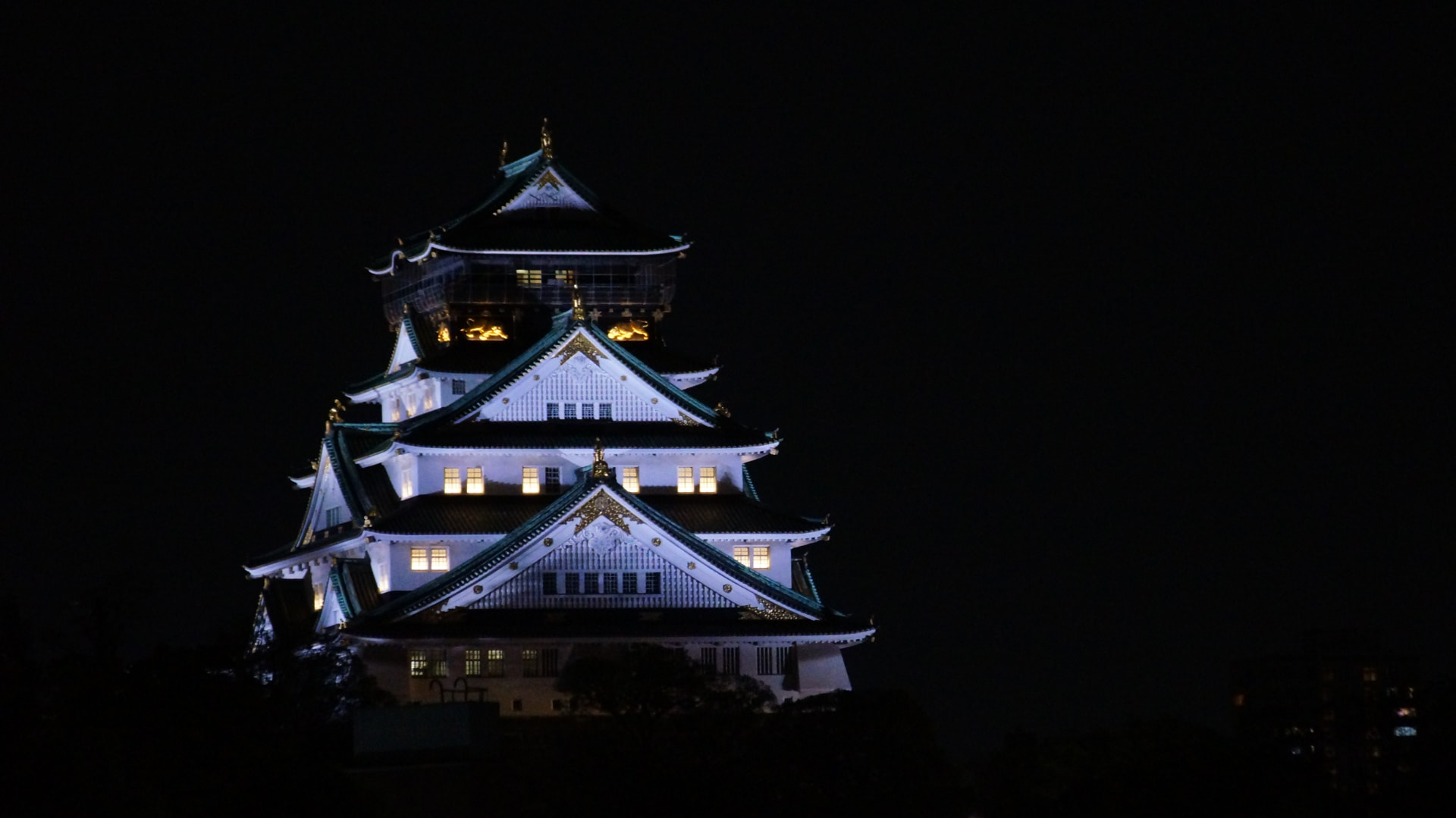 Osaka Castle keep lit against the night sky
