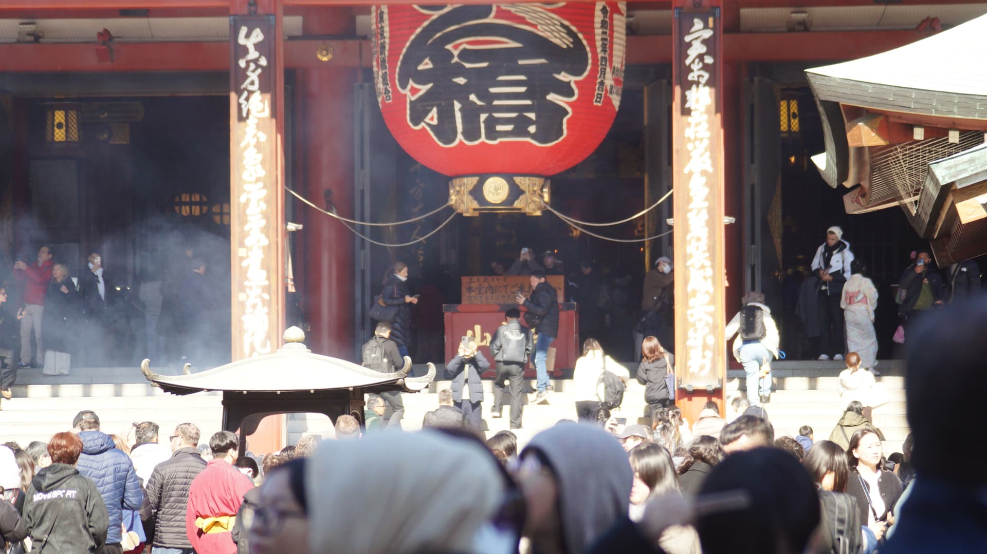 Crowds and incense smoke before the main hall at Sensoji temple